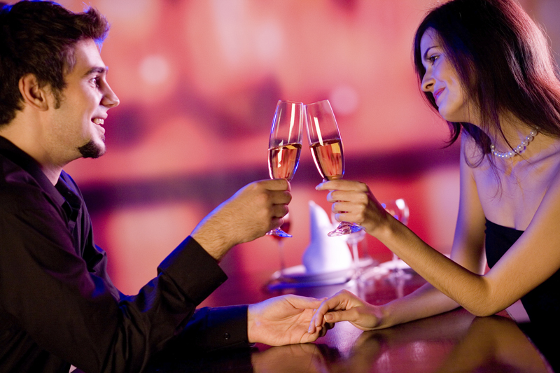 Young couple celebrating with champagne together