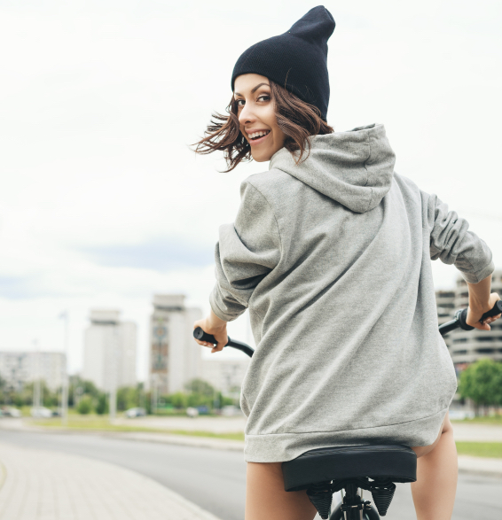 Young hipster girl with black bike