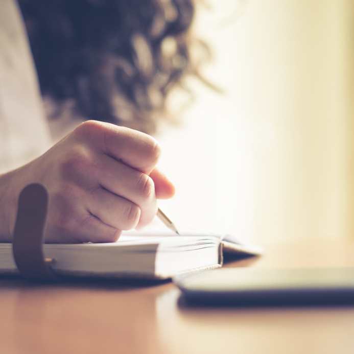 beautiful woman at home writing and working